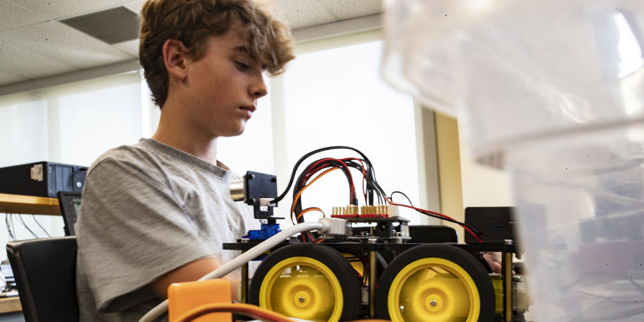 Student working on a robotic car