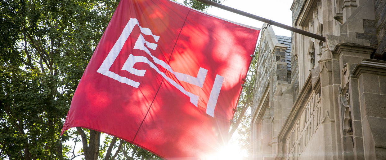 The cherry red Temple T flag flying on Main Campus