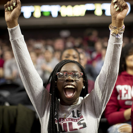 Student cheering at a Temple basketball game.