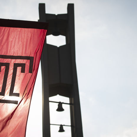 Temple "T" flag flying in front of the Bell Tower.