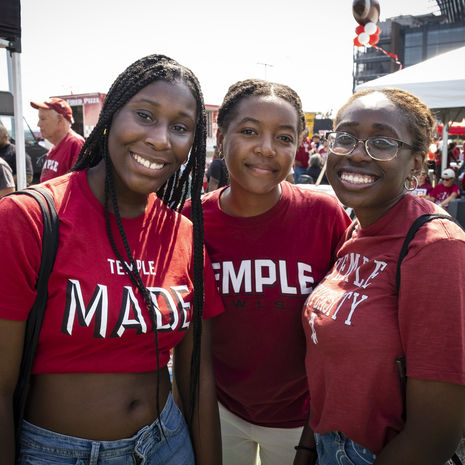 Three smiling students wearing Temple Made t shirts