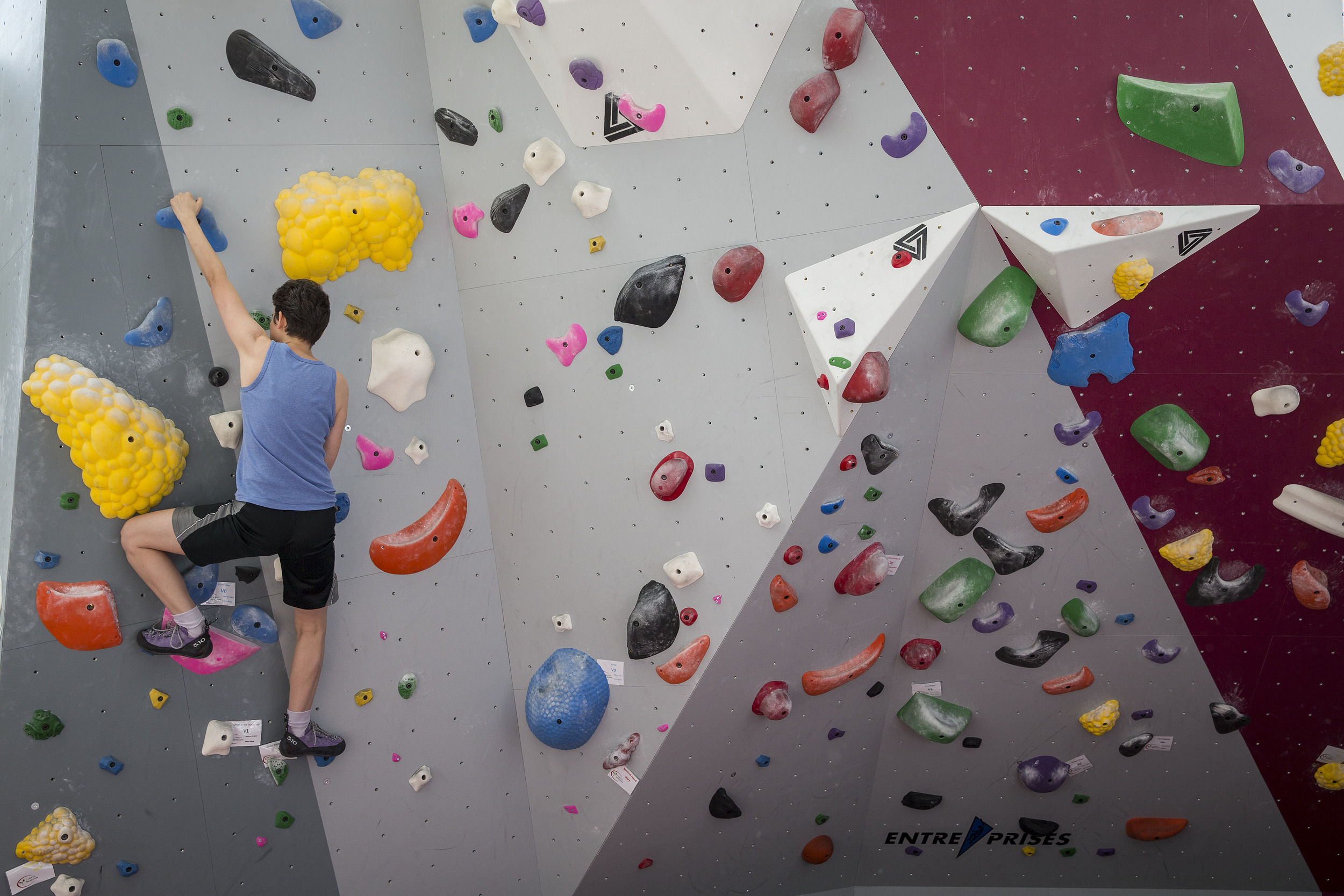 student conquering the rock climbing wall in the STAR Complex.