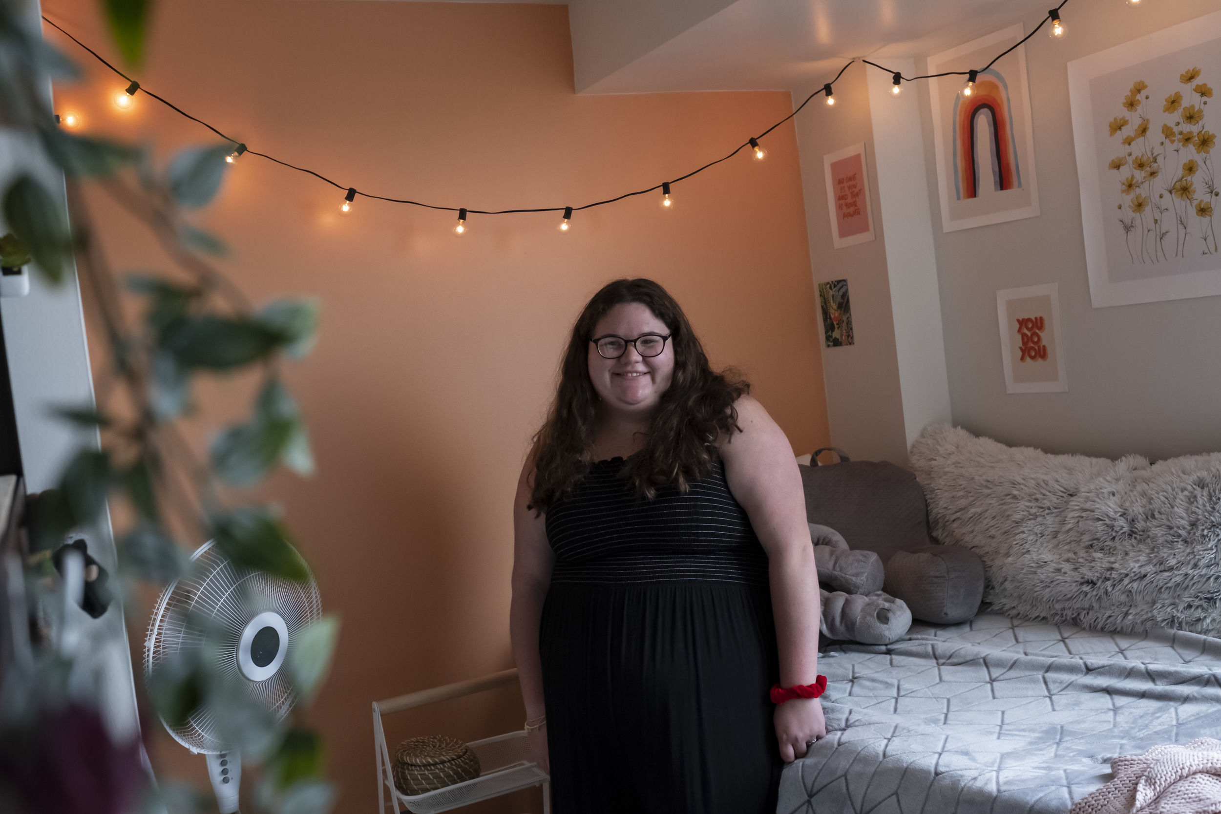 A student sits in their newly decorated room at Temple University.