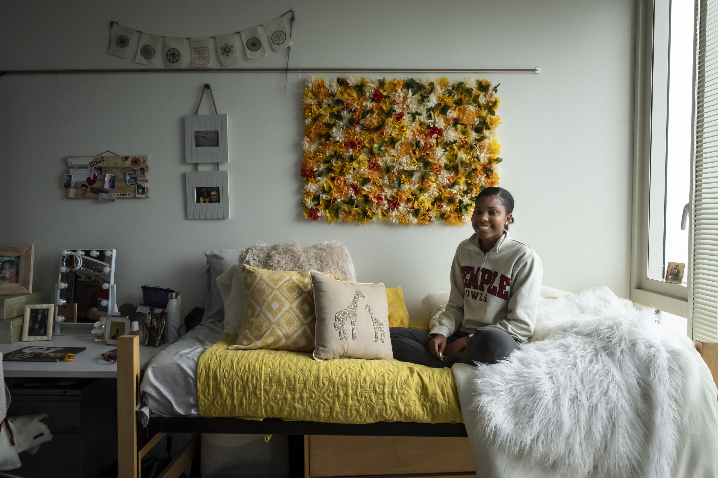 A student sits in their newly decorated room at Temple University.