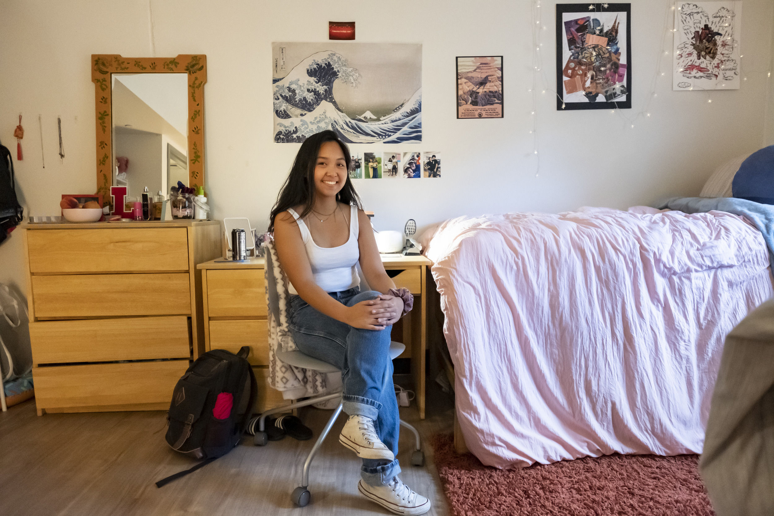 A student sits in their newly decorated room at Temple University.