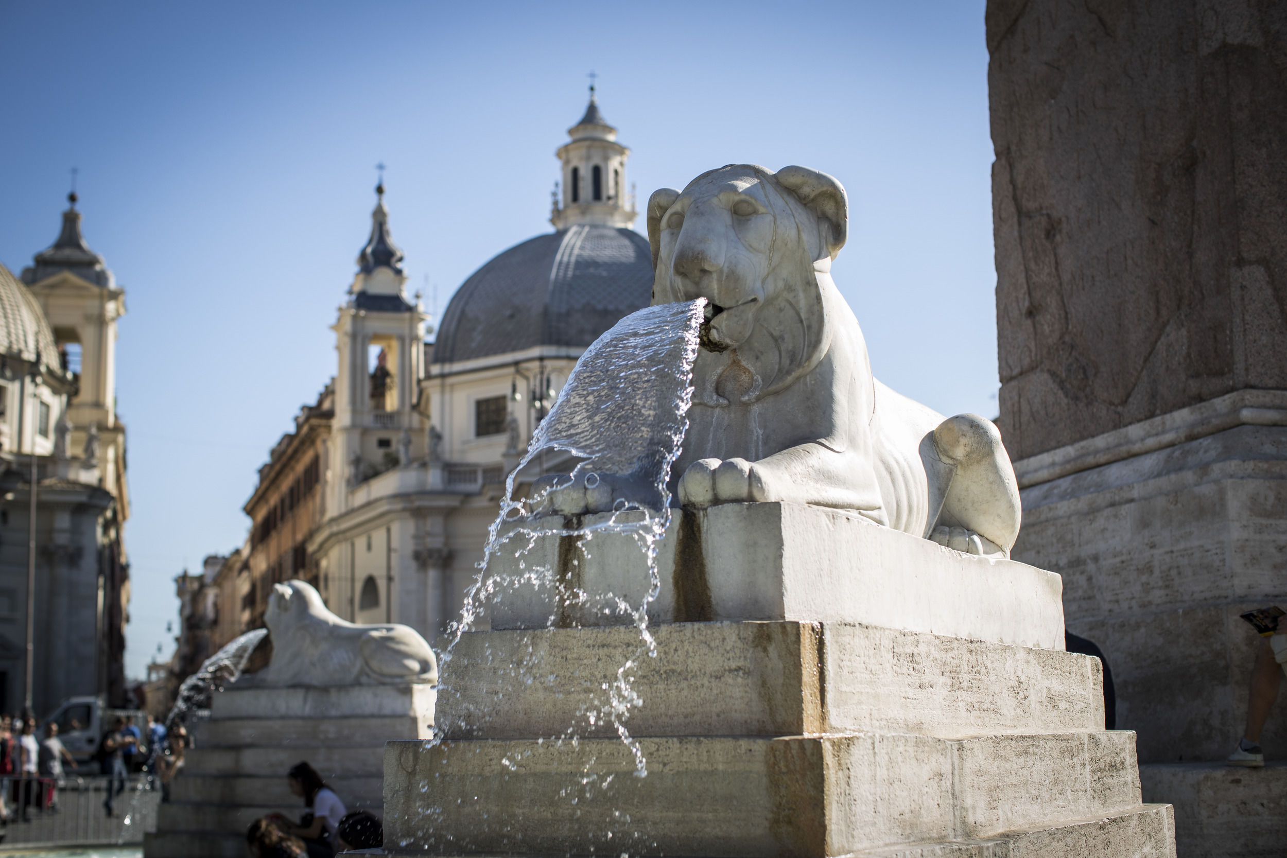 A lion shaped fountain spitting water in central Rome. 