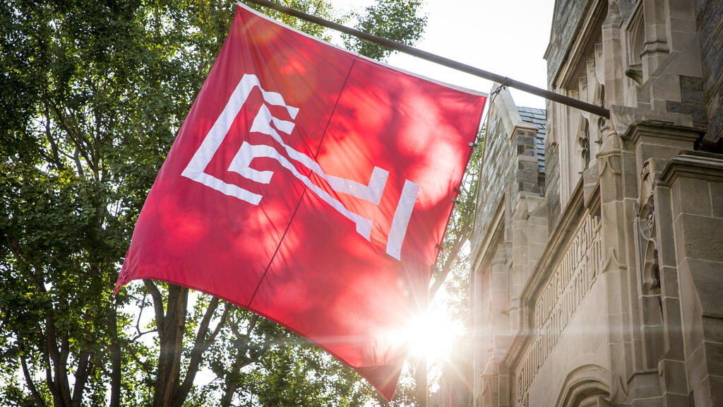 The cherry red Temple T flag flying on Main Campus