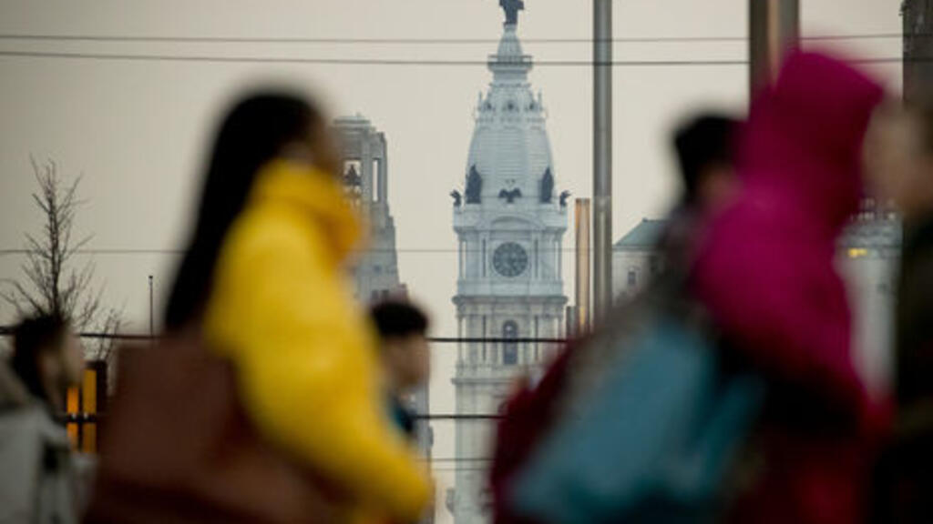 Students walking across Broad Street. Independence Hall seen in background. 