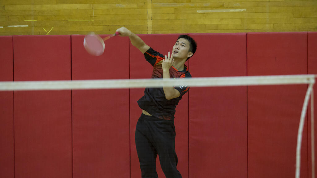 student playing badminton.