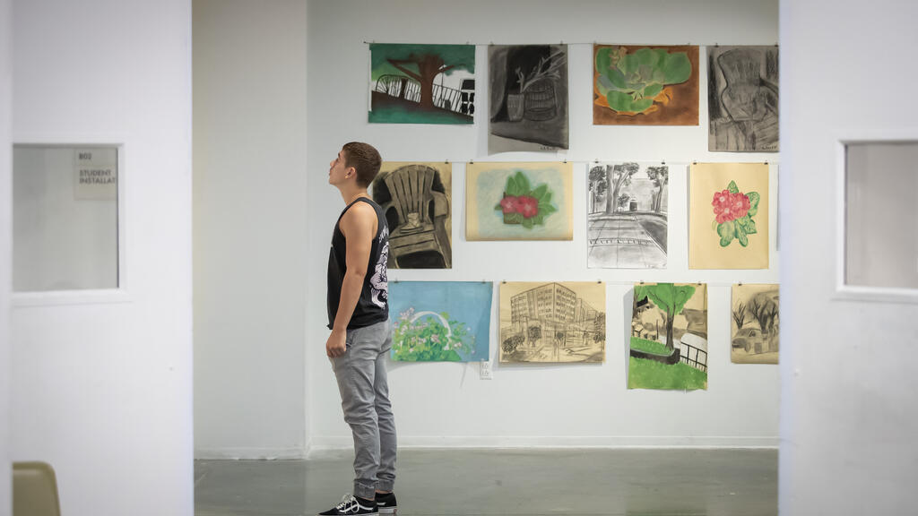 Tyler student looking at artwork.