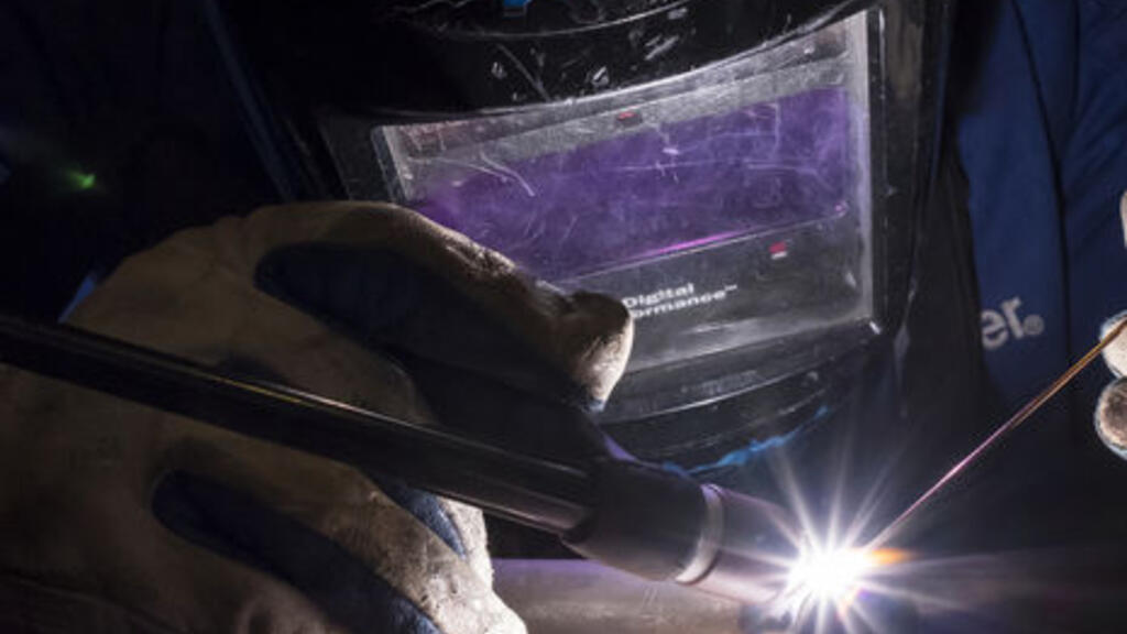 Student working with welding torch.