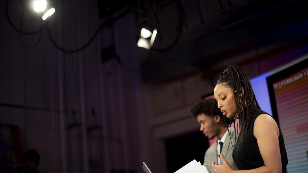 Two Klein broadcasting students being filmed presenting the news