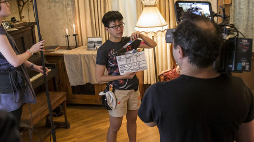 Students on a film set with sound equipment and camera 