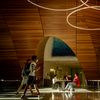 Two students wearing face coverings walk through Charles Library on Temple's Main Campus