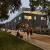Students walking by Charles Library in the evening.