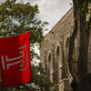 Temple flag and stone building with tree in front of it