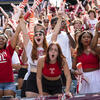 students cheering at a Temple football game.