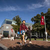 students walking across campus on a sunny day.