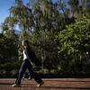 student walking across campus on a sunny fall day.