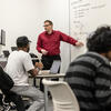 Students with professor in class.