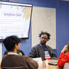 A group of students talking in a classroom
