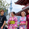 Asakusa friends walk together beneath Tokyo Skytree.