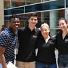Four of Temple's pre-college mentors stand together with arms around each other smiling for a photo.