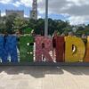 Students posing behind the MERIDA sign in Mexico