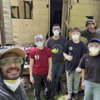 A selfie of a group of students at a construction site