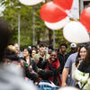 Students walking on campus with balloons