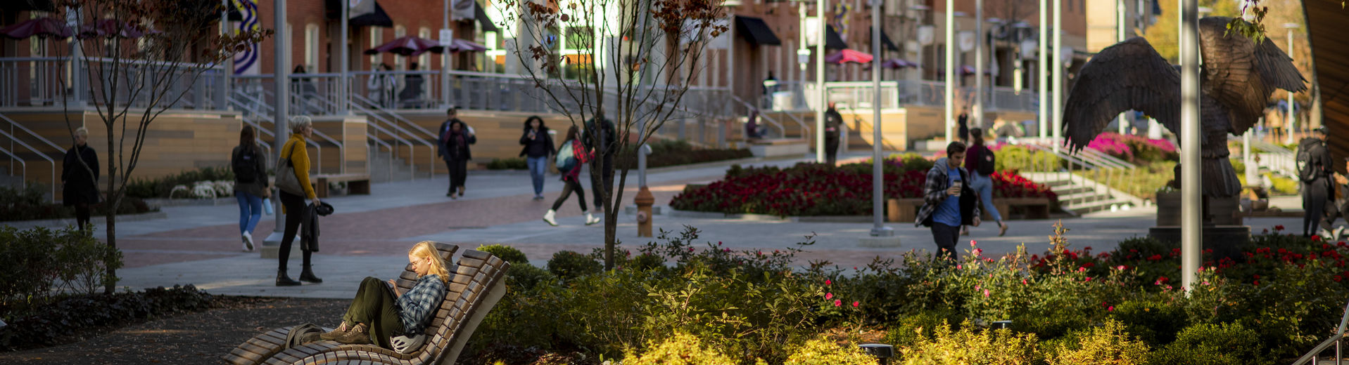 Students walking through O'Connor Plaza on a sunny fall day.