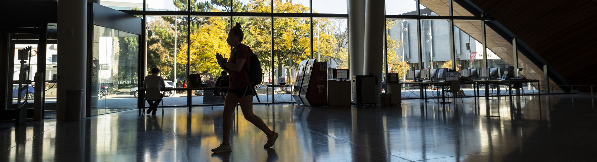 Students walking through the Charles Library lobby on Main Campus