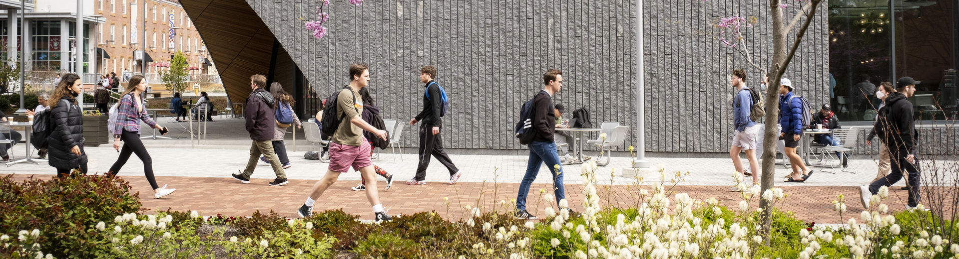 students walking across campus on a spring day.