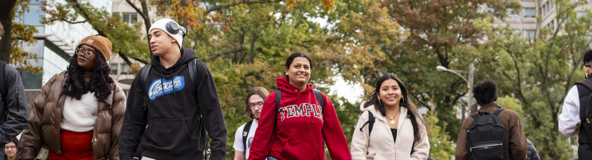 students walking across campus on a fall day.