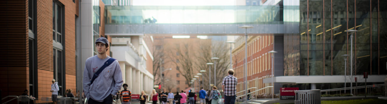 a student walking across main campus